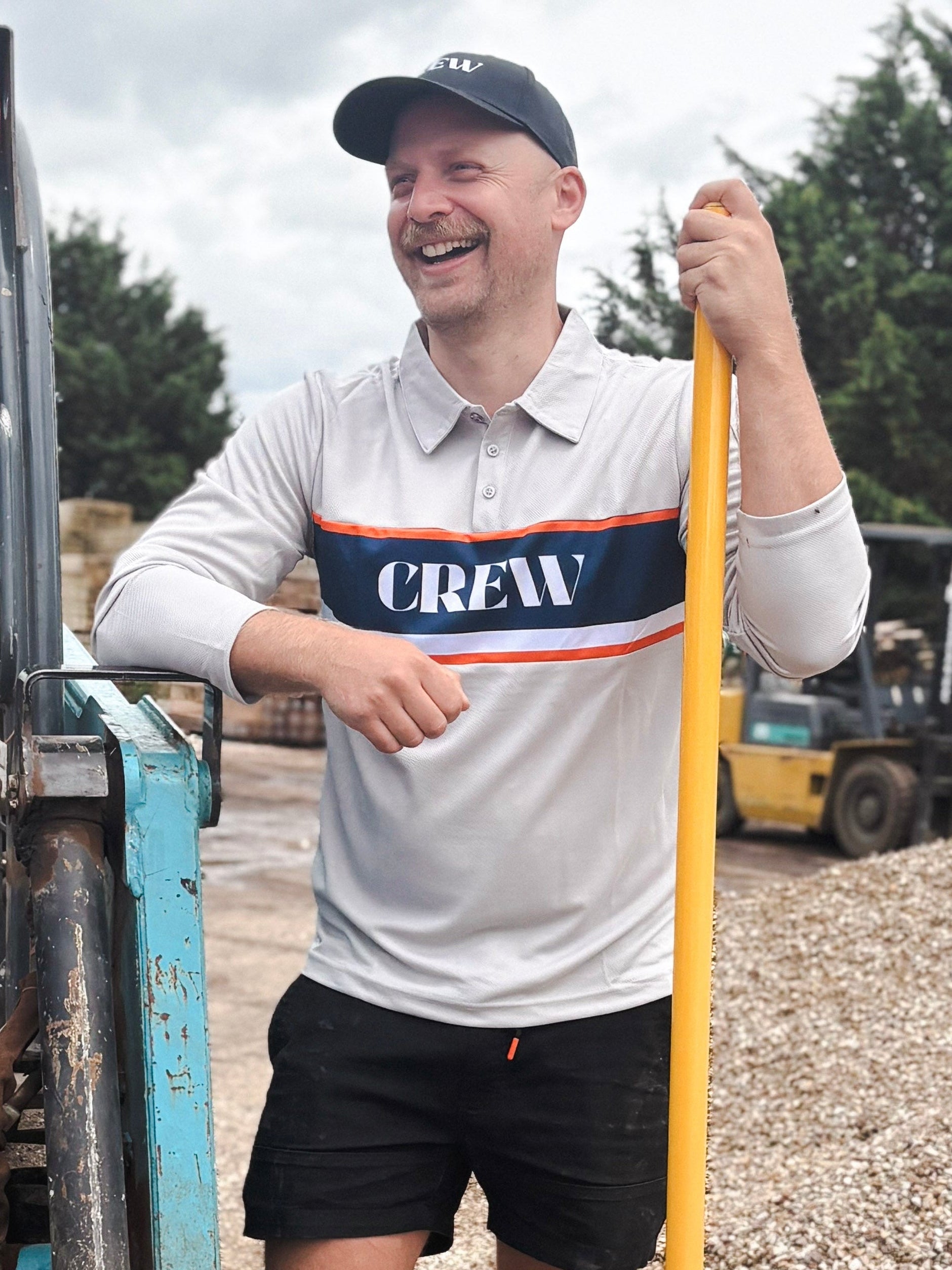 CREW light grey long sleeve work polo with navy chest panel, white stripe detail and button collar on white background